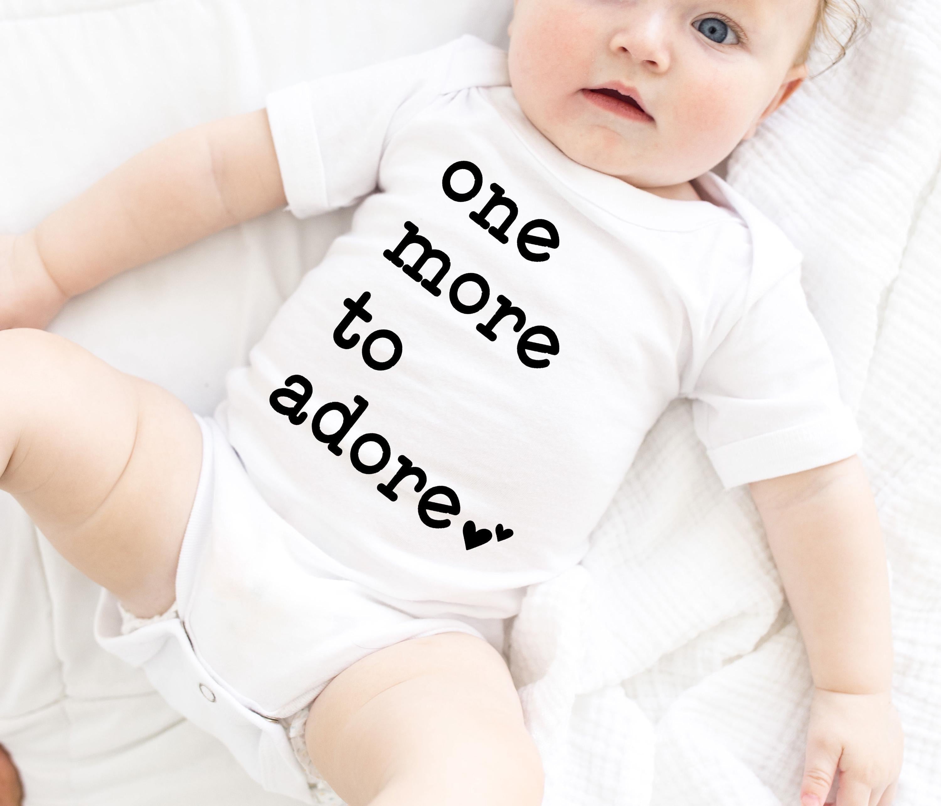 Close-up of the One More to Adore baby announcement design