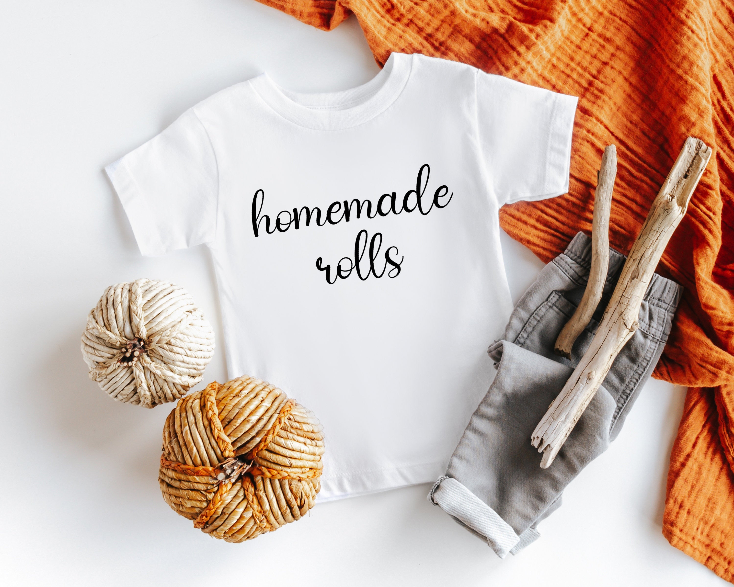 Lifestyle mockup featuring Homemade Rolls Thanksgiving Baby Onesie® – Style 2