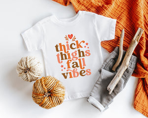 Main product mockup of Thick Thighs & Fall Vibes Baby Onesie® – Style 2