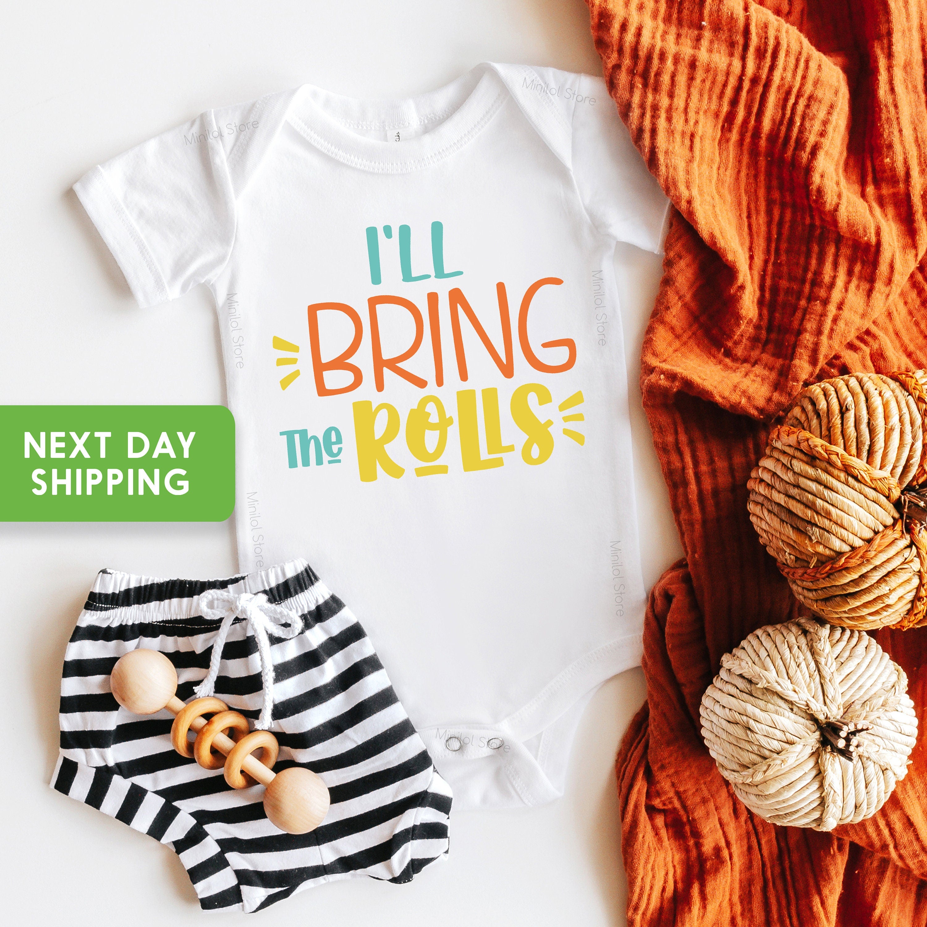 Main product mockup of I'll Bring the Rolls First Thanksgiving Baby Onesie®