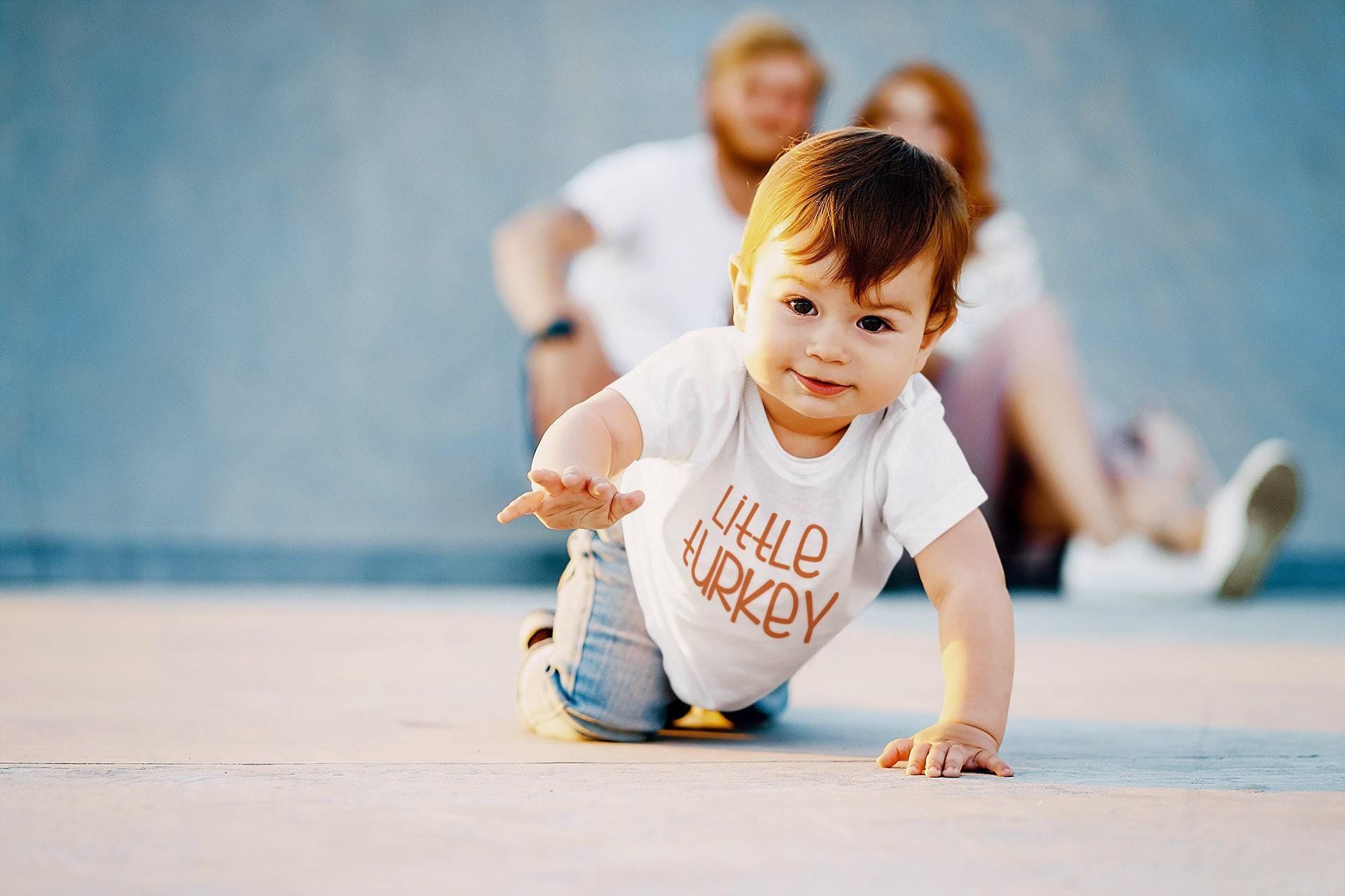 Lifestyle mockup featuring Little Turkey Thanksgiving Baby Onesie® – Style 2