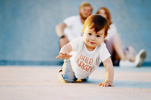 Lifestyle mockup featuring Little Turkey Thanksgiving Baby Onesie® – Style 2