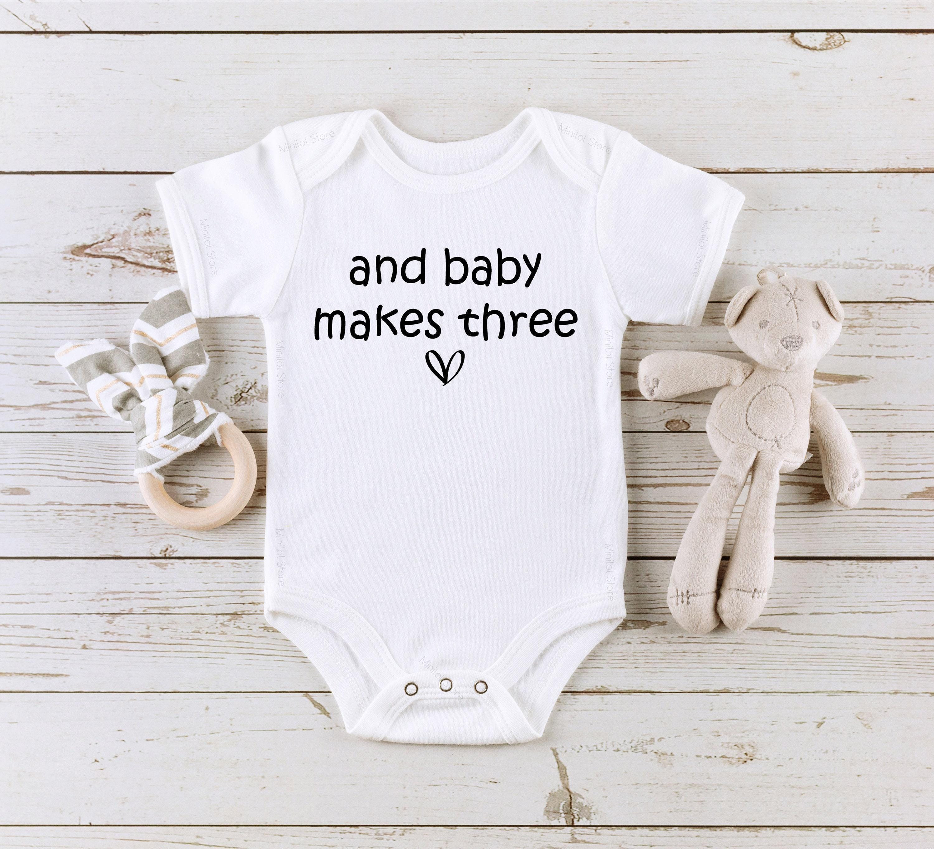Close-up of the Baby Makes Three baby announcement design