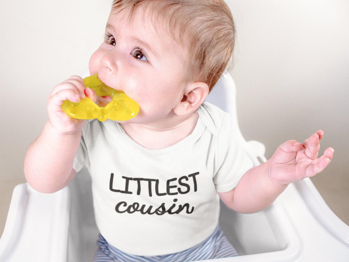 Pregnancy Announcement Cousin Reveal typographic design on Baby Short Sleeve Onesie®