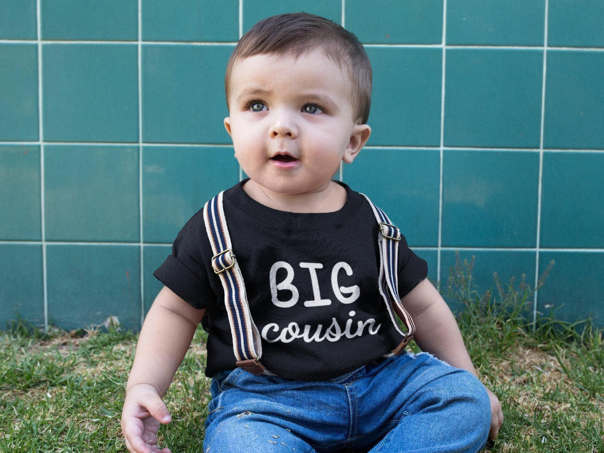 Pregnancy Announcement Cousin Reveal typographic design on Baby Short Sleeve Onesie®
